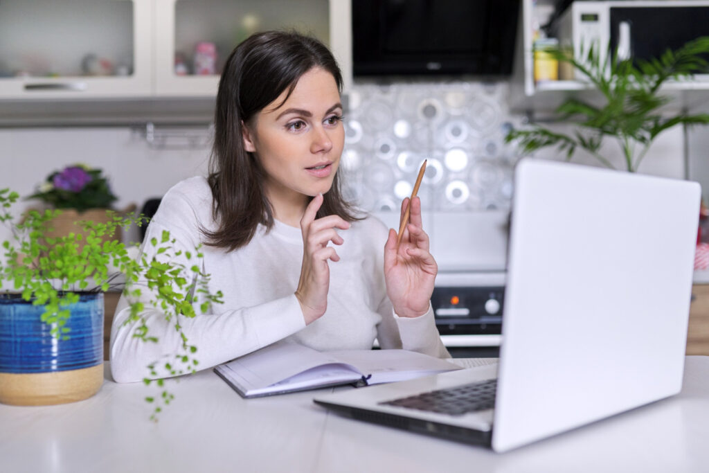 Woman thinking at laptop
